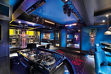 A pioneer dj mixer sits in a dark room