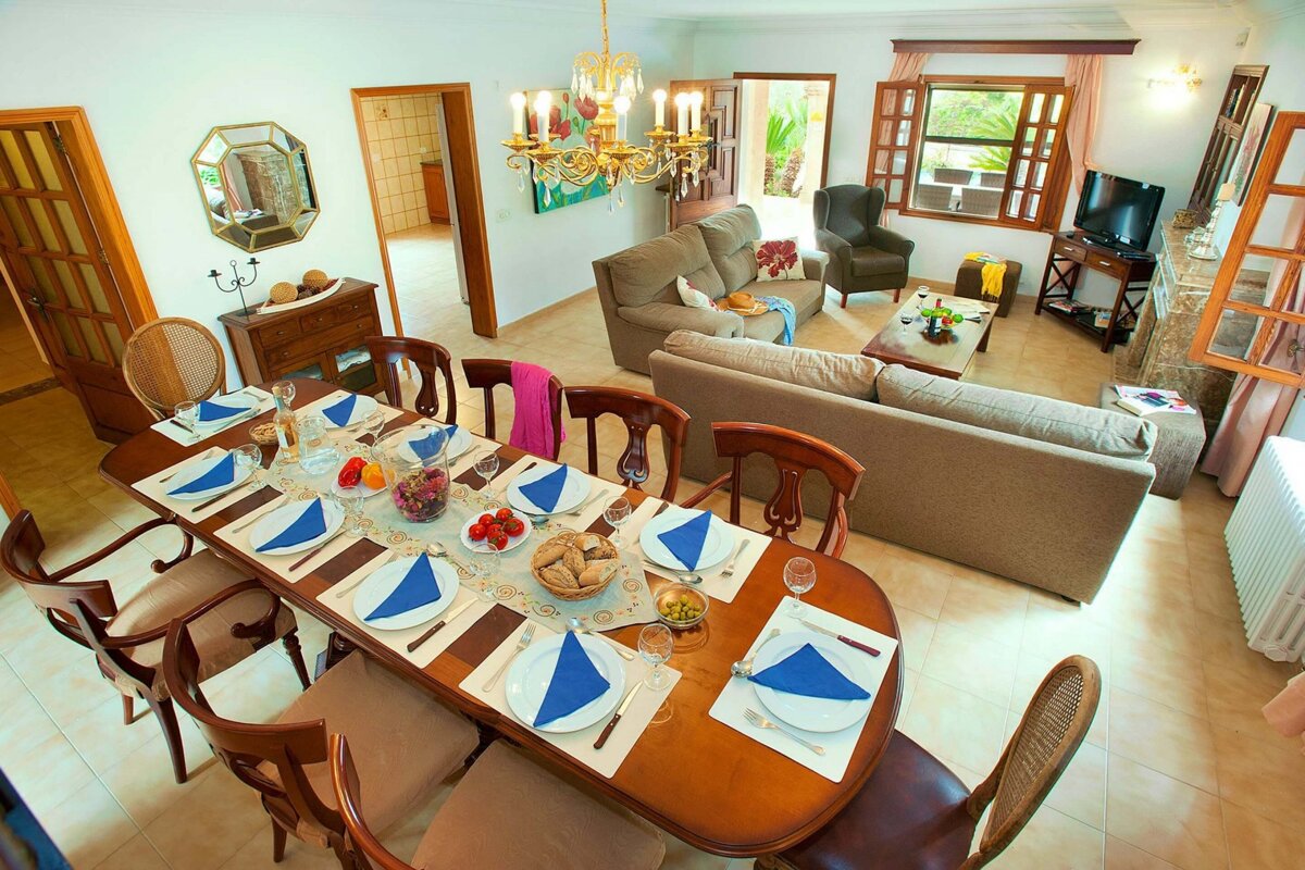 A living room with a dining table and chairs