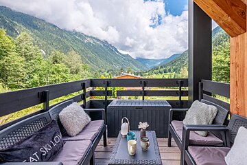 A balcony with a couch that says eat ski low