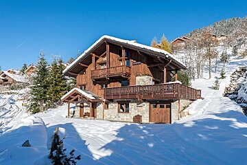 A snowy house with a blue sky in the background