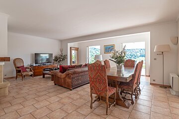 A living room with a dining table and chairs