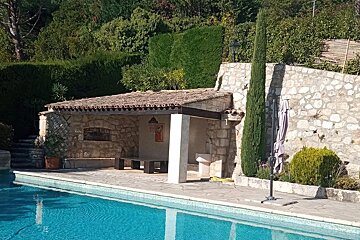 A swimming pool with a stone building in the background