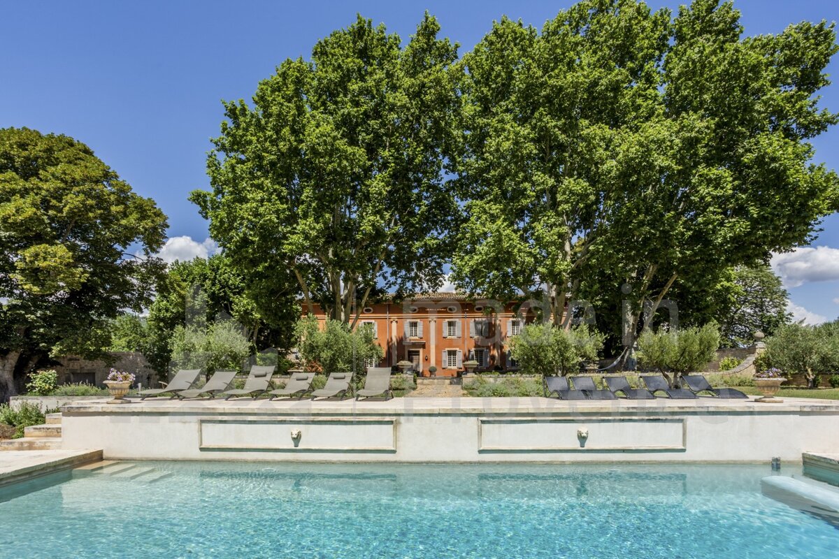 A large orange building with a swimming pool in front of it