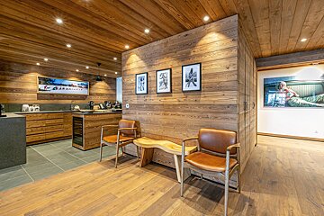 A kitchen with wood paneling and a picture of a woman on the wall