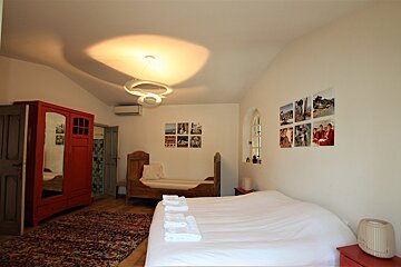 A bedroom with a bed and pictures on the wall