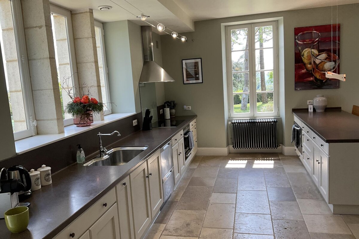 A kitchen with a sink and a picture on the wall
