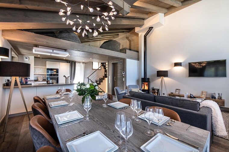 A dining room table with plates and glasses on it