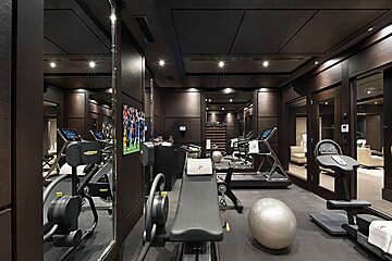 A gym with a soccer game on the wall