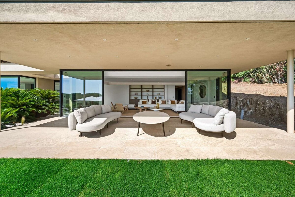 A living room with a lot of furniture and a sliding glass door
