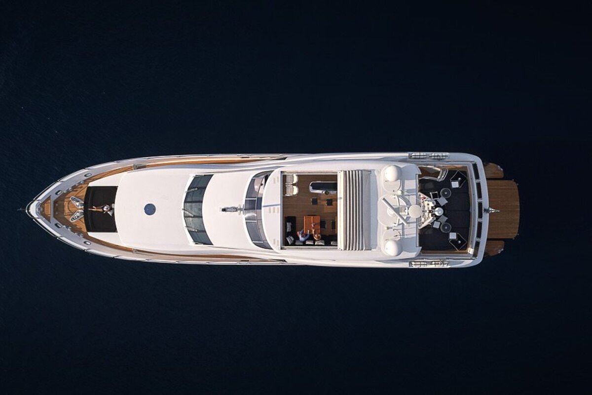 An aerial view of a large white yacht in the ocean