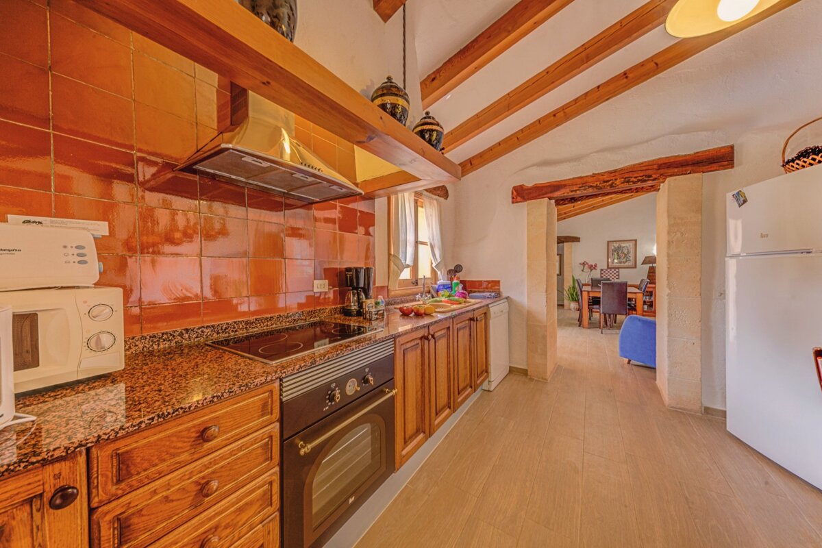 A kitchen with a stove top oven and a siemens microwave