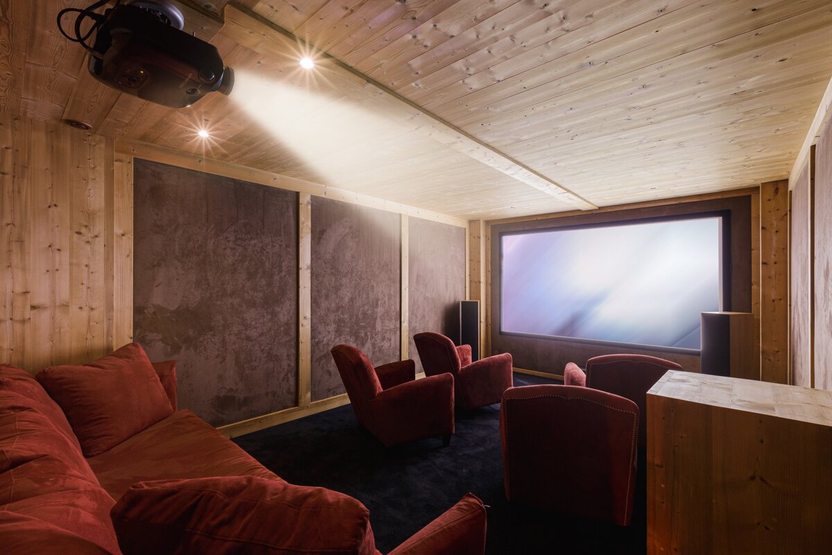 A room with a projector and a large screen