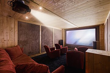 A room with a projector and a large screen