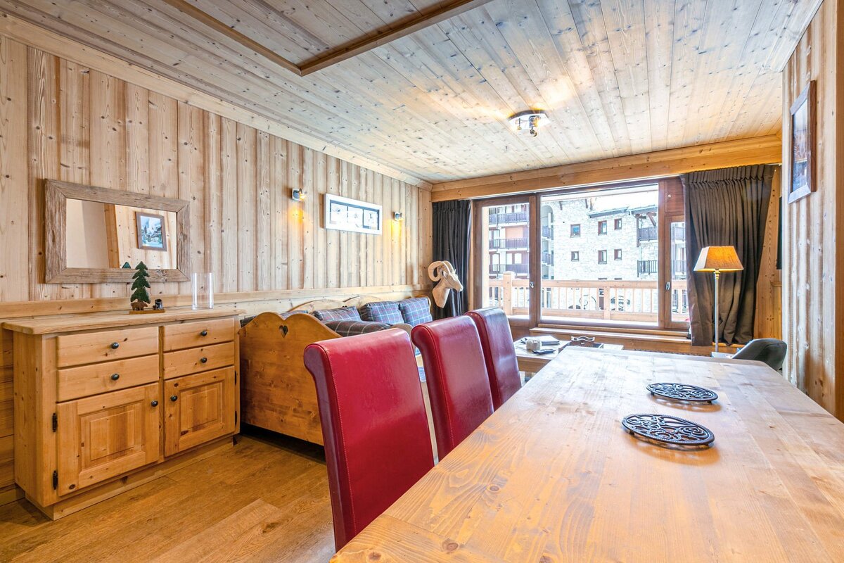 A living room with a dining table and chairs
