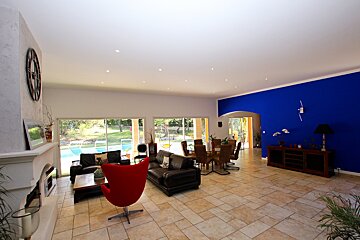 A living room with blue walls and a red chair