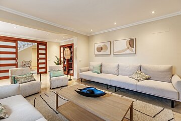 A living room with a couch and two chairs