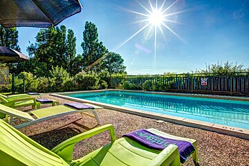 A swimming pool with a no diving sign on the fence
