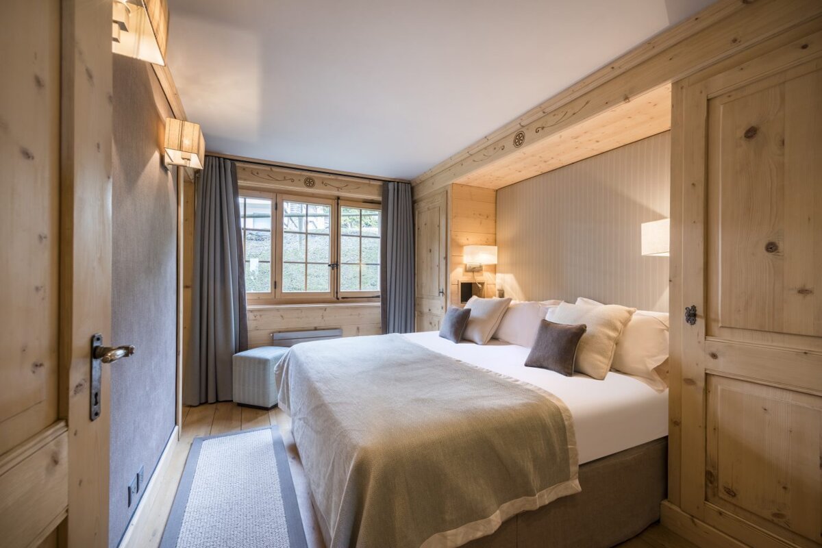 A bedroom with a large bed and a window