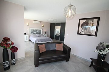 A bedroom with a picture of a woman on the wall