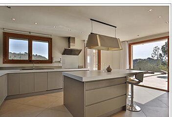 A kitchen with a large island in the middle