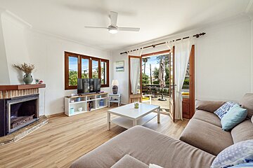 A living room with a ceiling fan and a couch