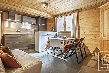 A kitchen with a table and chairs and a sign that says alpine-pro