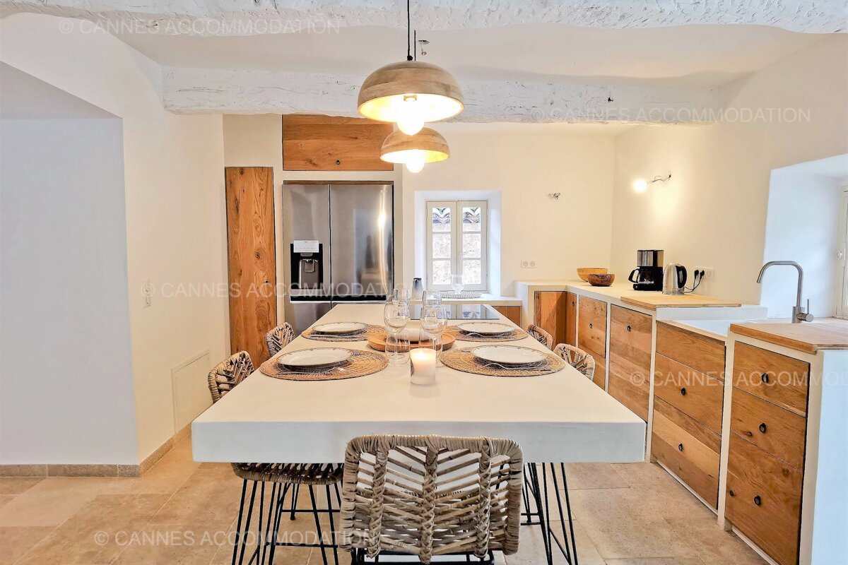 A cannes accommodation photo of a kitchen with a table and chairs