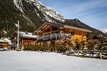 A picture of a house in the mountains with the word holidays at the bottom