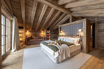 A bedroom with a bed and a tray of food on it