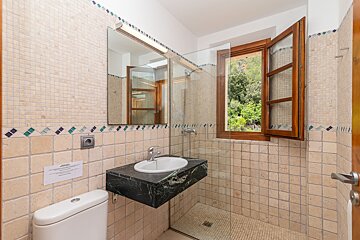 A bathroom with a sign on the wall that says warning