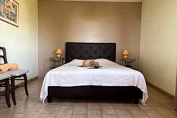 A bed with a straw hat on top of it