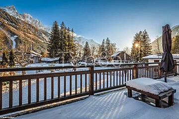 A snowy balcony with a view of the mountains