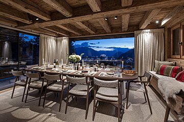 A dining room table with a view of the mountains