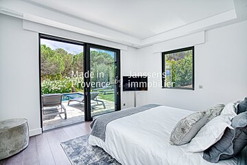 A bedroom with a sliding glass door that says made in provence