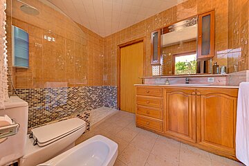 A bathroom with a toilet a sink and a mirror