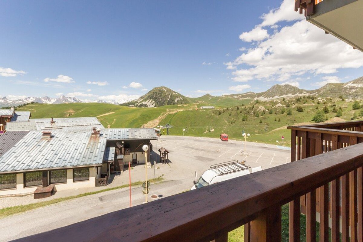 A balcony with a view of mountains and buildings