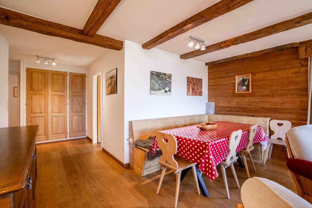 A dining room table with a red and white polka dot tablecloth