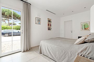 A bedroom with a bed and a sliding glass door