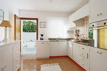 A kitchen with white cabinets and a candy oven