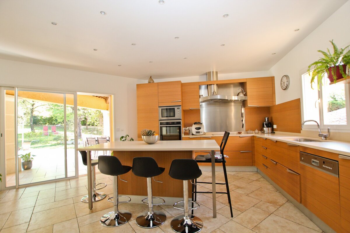 A kitchen with wooden cabinets and stainless steel appliances