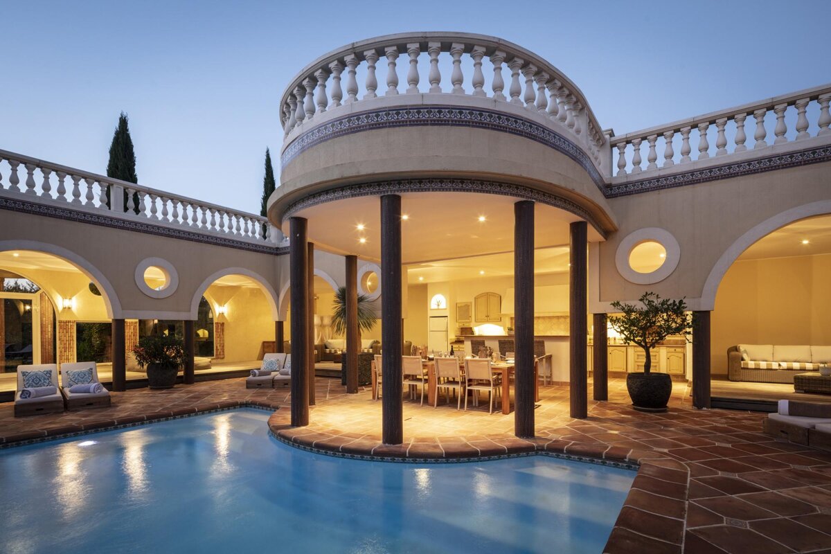 A large house with a swimming pool in the middle