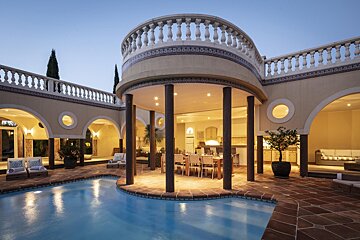 A large house with a swimming pool in the middle