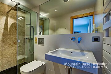 A bathroom with a toilet and a sink from mountain base