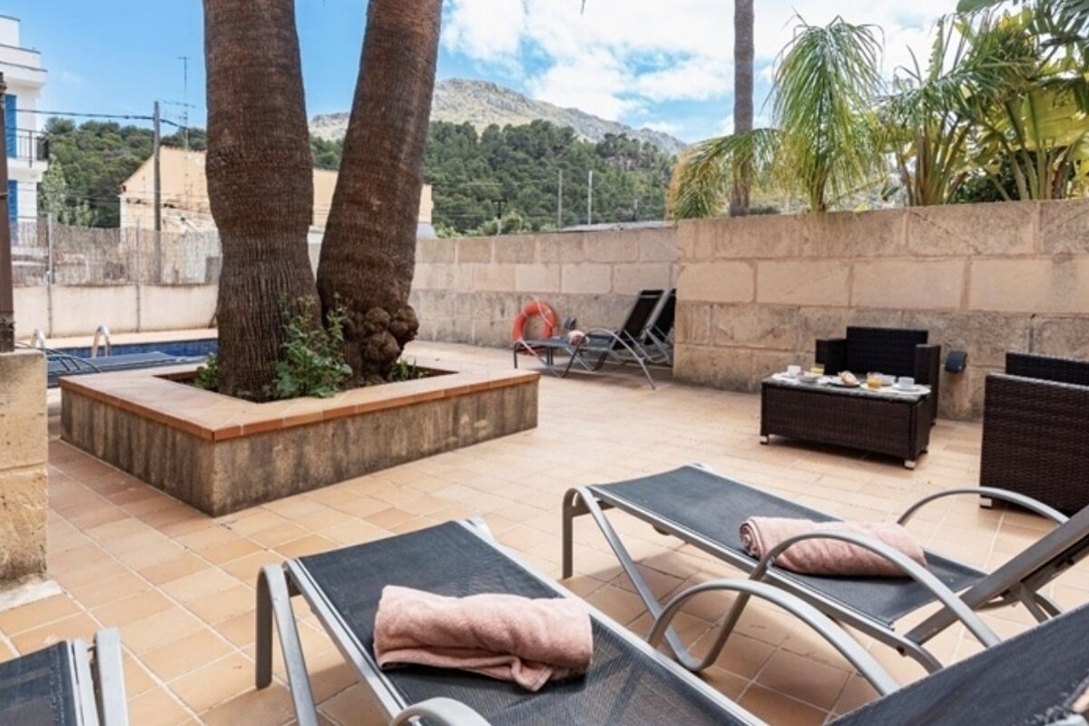 A patio area with lounge chairs and a table