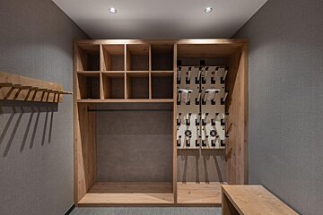 A closet with a lot of shelves and hooks