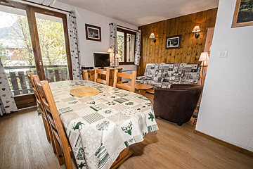 A living room with a table and chairs and a couch