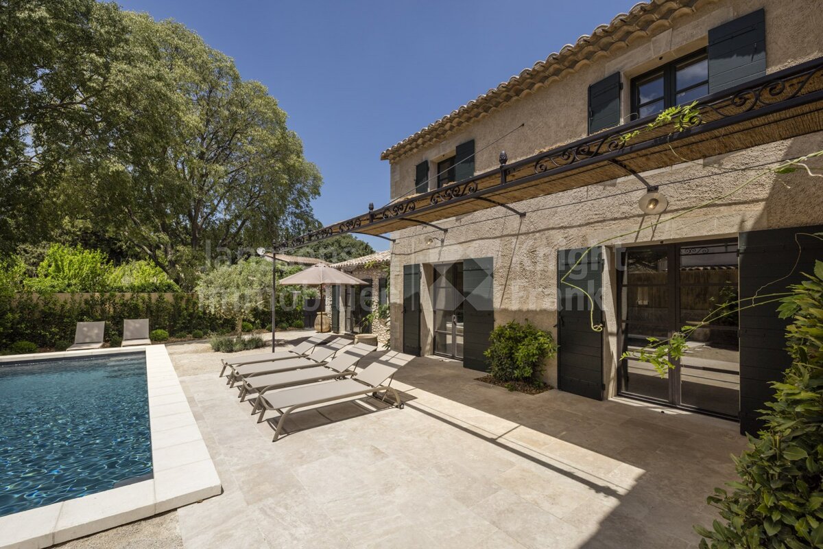 A large house with a swimming pool in front of it