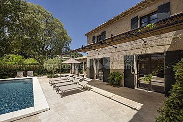 A large house with a swimming pool in front of it