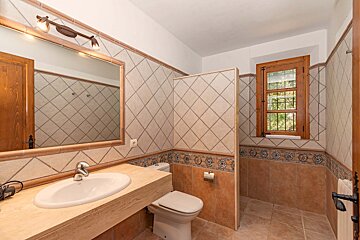 A bathroom with a sink toilet and mirror