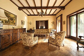 A living room with a couch and two chairs
